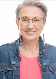 A woman with glasses and a jean jacket.